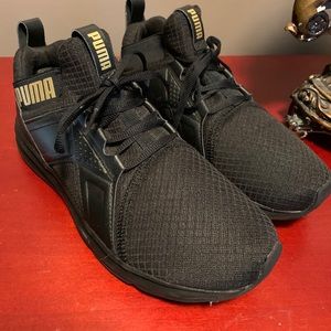 Puma Black and Gold slip on sneakers